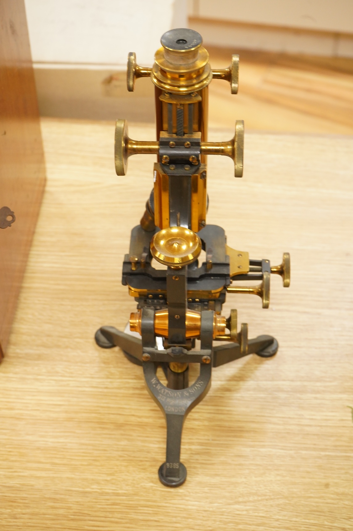 A early 20th century brass compound monocular microscope, by W. Watson and Sons, 313, High Holborn, London, number 9385, mahogany cased, with accessories including - four additional objectives, two eyepieces and a bull’s
